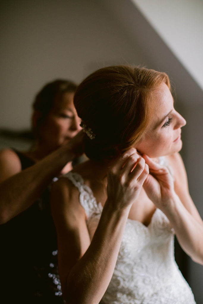 bride-putting-earrings-on